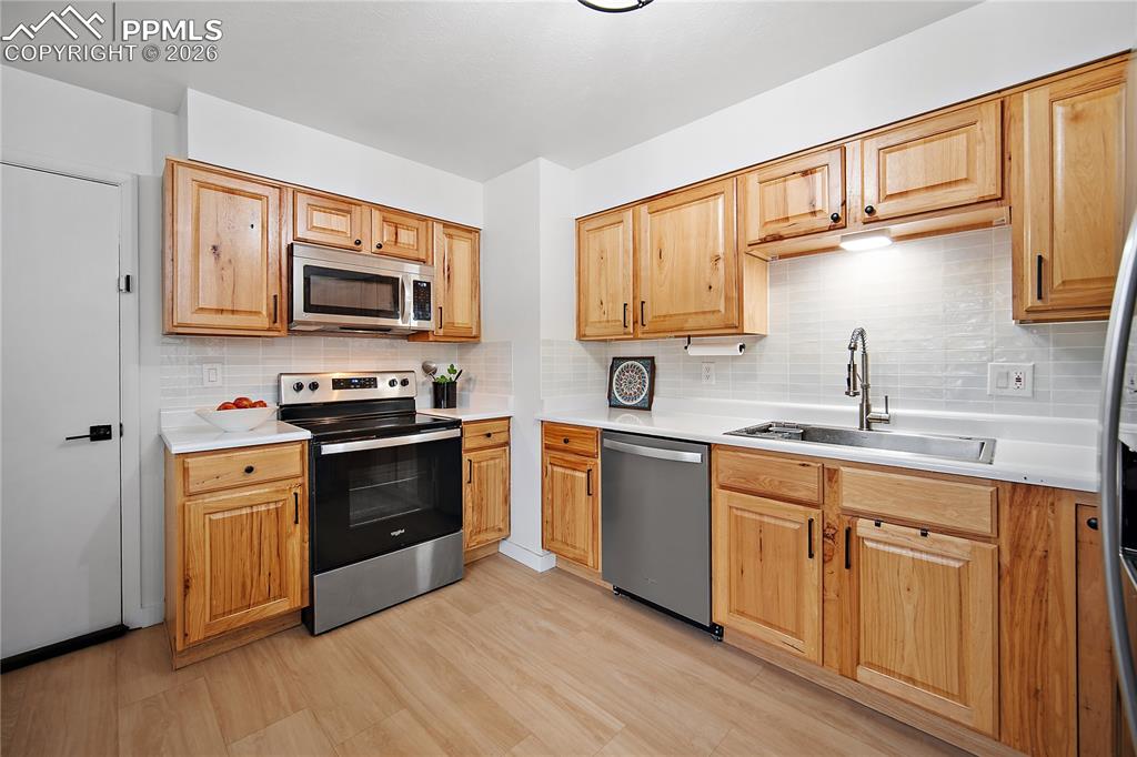 Image 10 of 44: Kitchen with SS and newer cabinetry. 