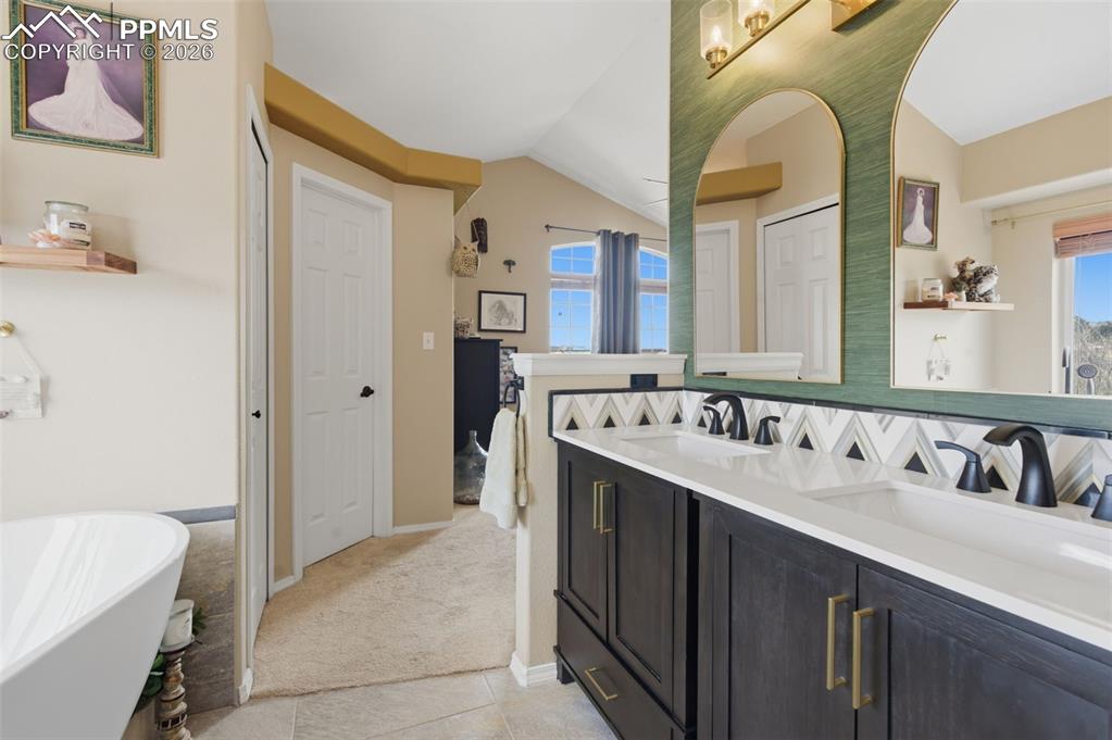 Image 19 of 50: Primary bathroom with walk in closet