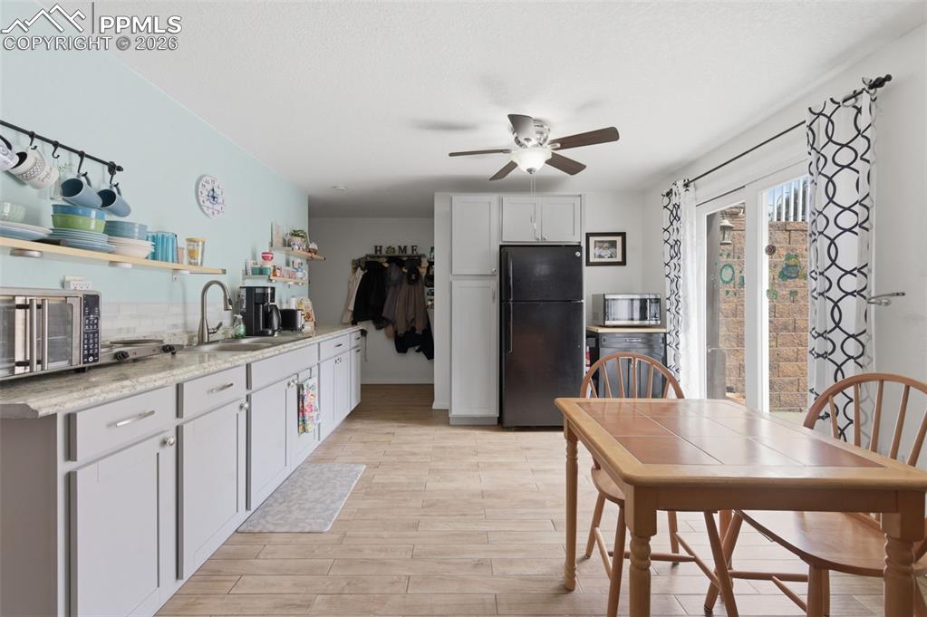 Image 25 of 50: Basement kitchenette/wet bar and outside access to patio and stairway to ma