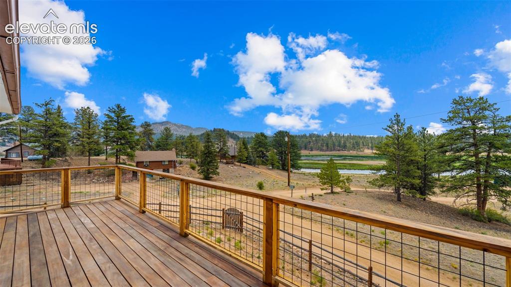 Image 38 of 45: Beautiful Tiger Wood wrap deck with a view!!