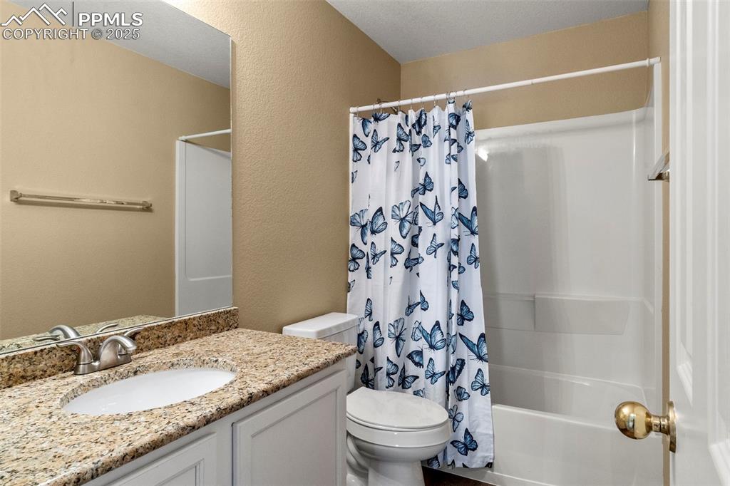 Image 15 of 25: Full bathroom featuring shower / bathtub combination with curtain, vanity, 