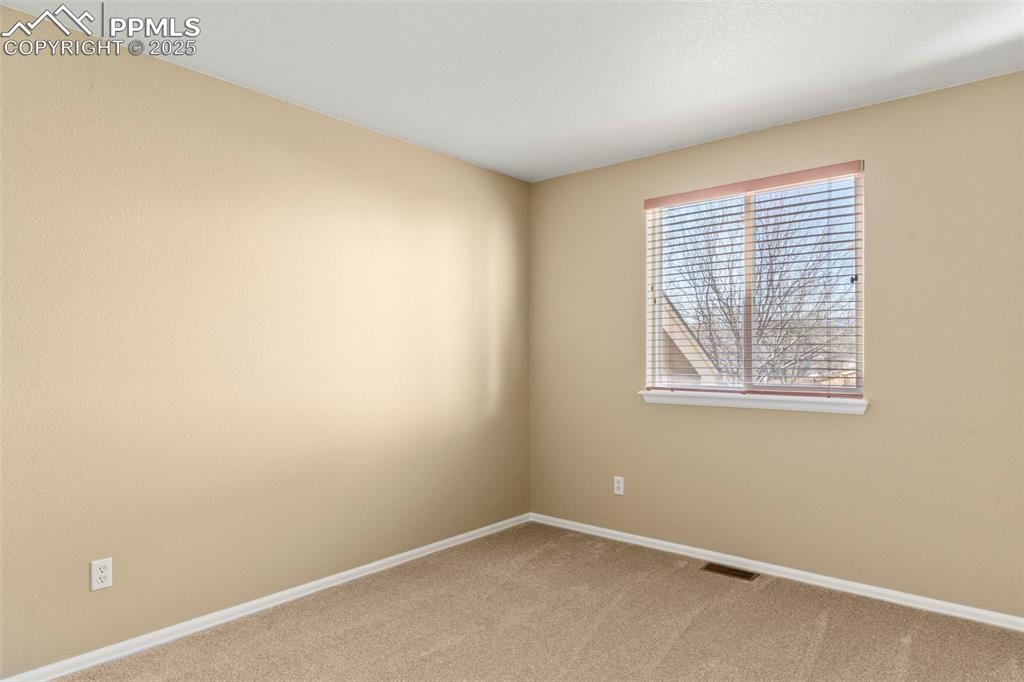 Image 16 of 25: Carpeted empty room with baseboards