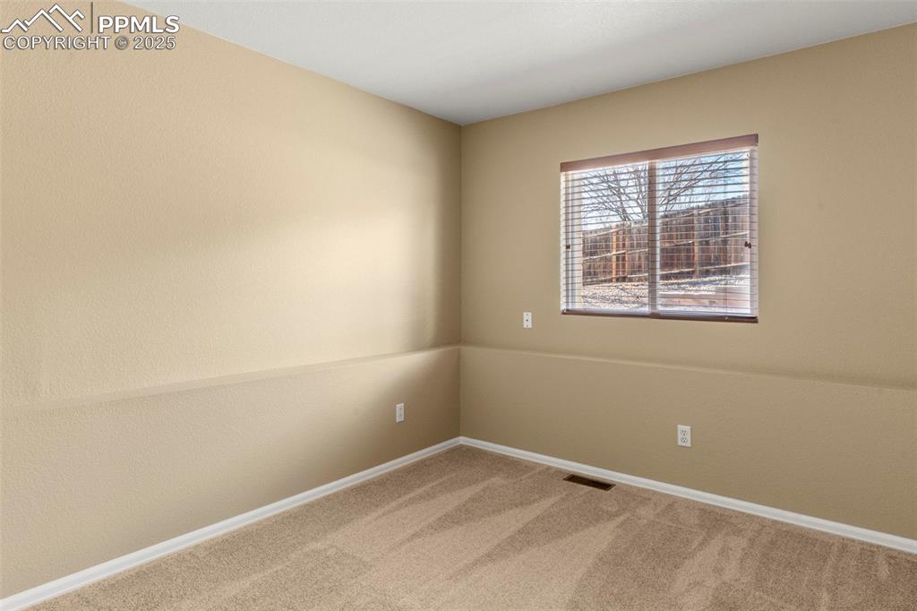 Image 20 of 25: Unfurnished room with light colored carpet and baseboards