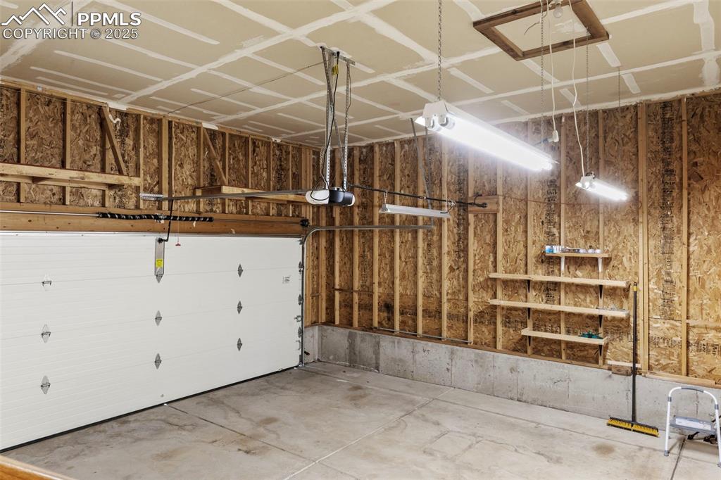 Image 23 of 25: Garage featuring a garage door opener