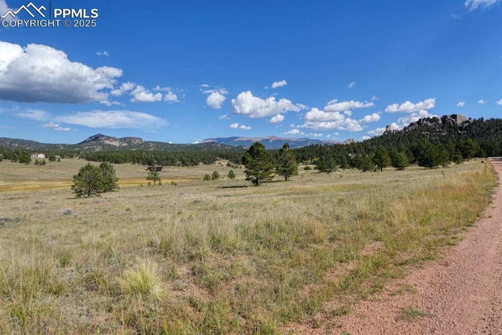 Image 13 of 16: View of mountain background featuring rural landscape