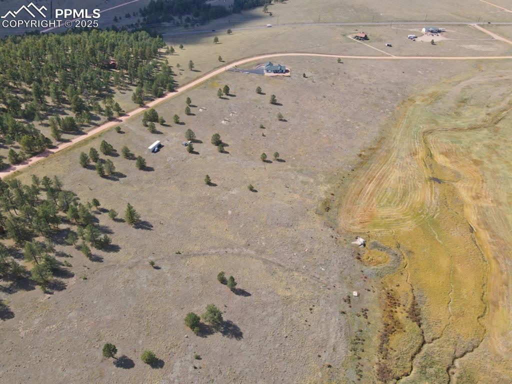 Image 5 of 16: Aerial view of property and surrounding area featuring rural landscape