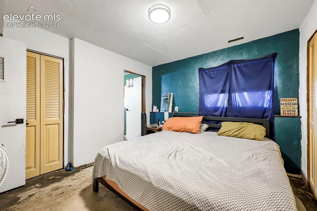 Image 10 of 17: Room featuring a window, built-in closet with louvered doors, and a ceiling
