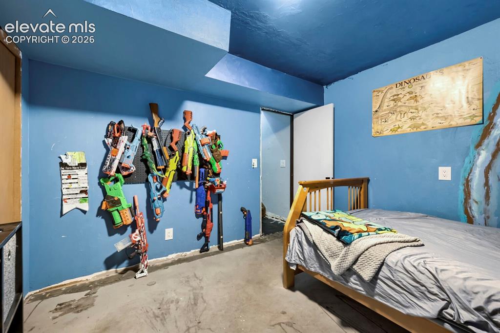 Image 14 of 17: Room featuring blue painted walls and ceiling, a built-in wall-mounted stor