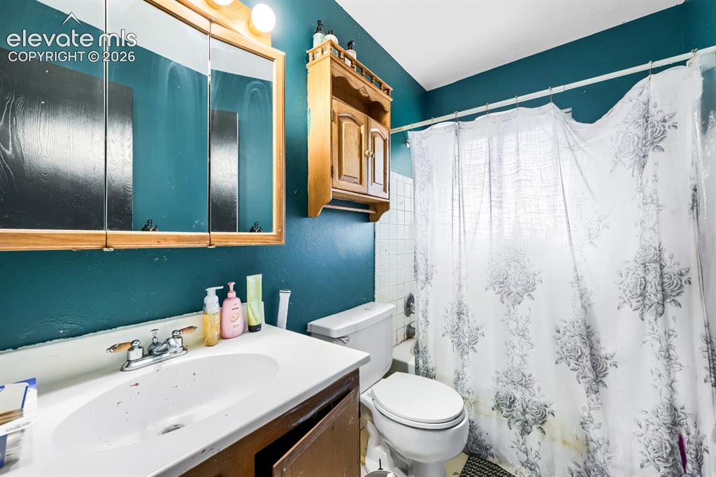 Image 15 of 17: Bathroom featuring a vanity with an integrated sink, a medicine cabinet wit