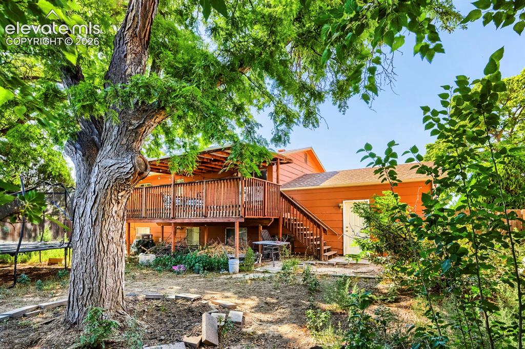 Image 17 of 17: Wood-sided exterior featuring an expansive upper-level deck with wood raili