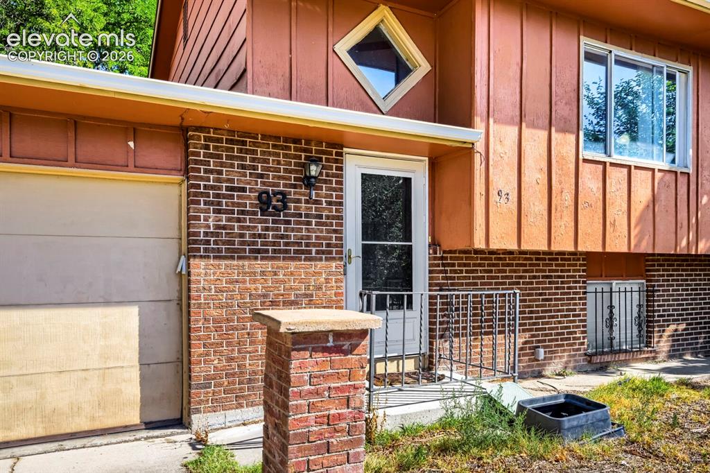 Image 2 of 17: Brick and vertical panel exterior featuring a diamond-shaped window accent,