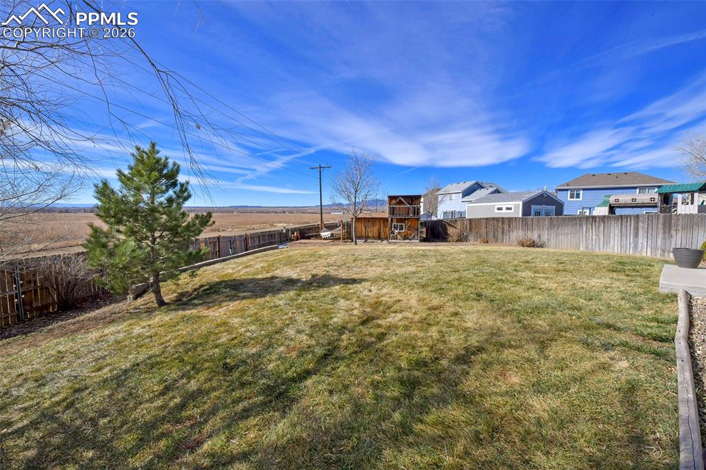 Image 22 of 27: Fenced backyard featuring a residential view