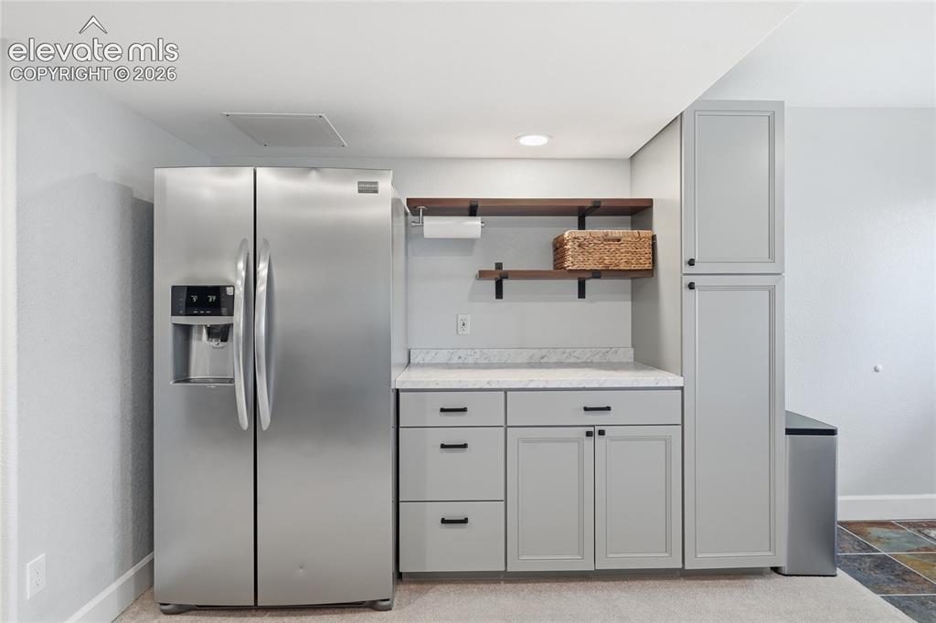 Image 35 of 49: Cabinets and Fridge in Basement