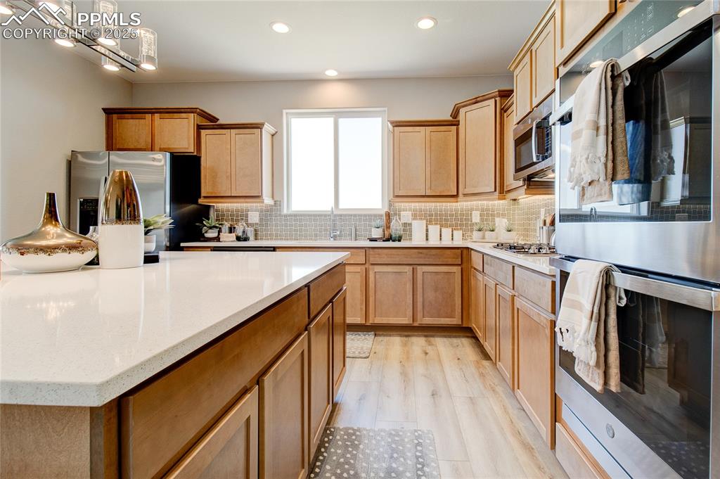 Image 11 of 23: Kitchen with appliances with stainless steel finishes, recessed lighting, d