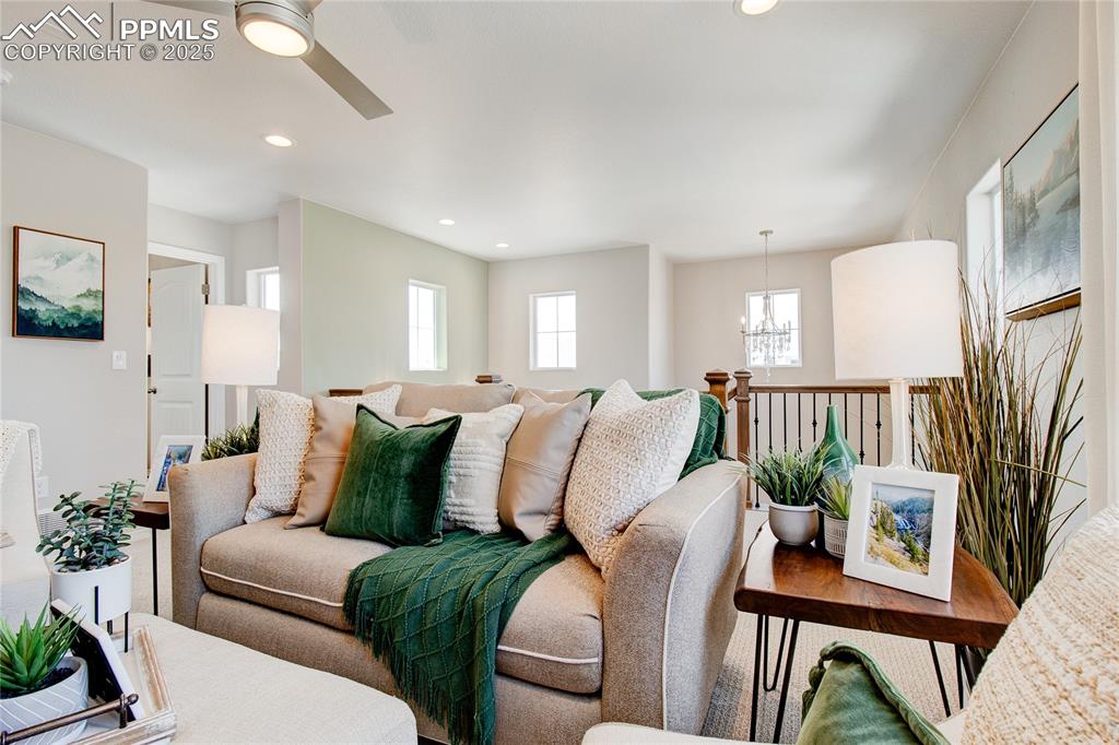 Image 15 of 23: Living room featuring a chandelier, a ceiling fan, and recessed lighting
