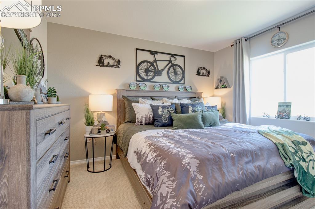 Image 21 of 23: Bedroom featuring light colored carpet and baseboards