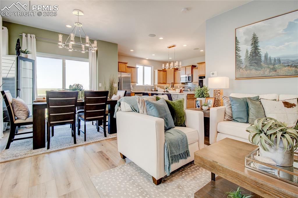 Image 7 of 23: Living room featuring a chandelier, light wood-style flooring, and recessed