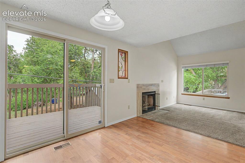 Image 10 of 30: Interior space featuring wood-finish flooring, a sliding glass door opening