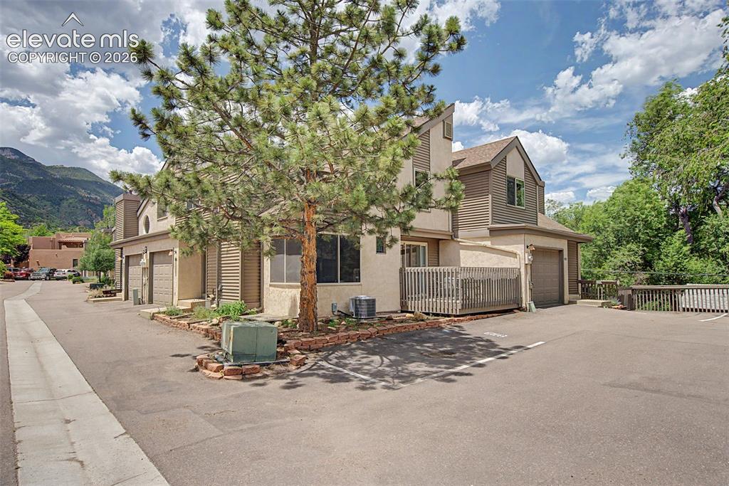 Image 4 of 30: Multi-level residential structure featuring stucco and horizontal siding