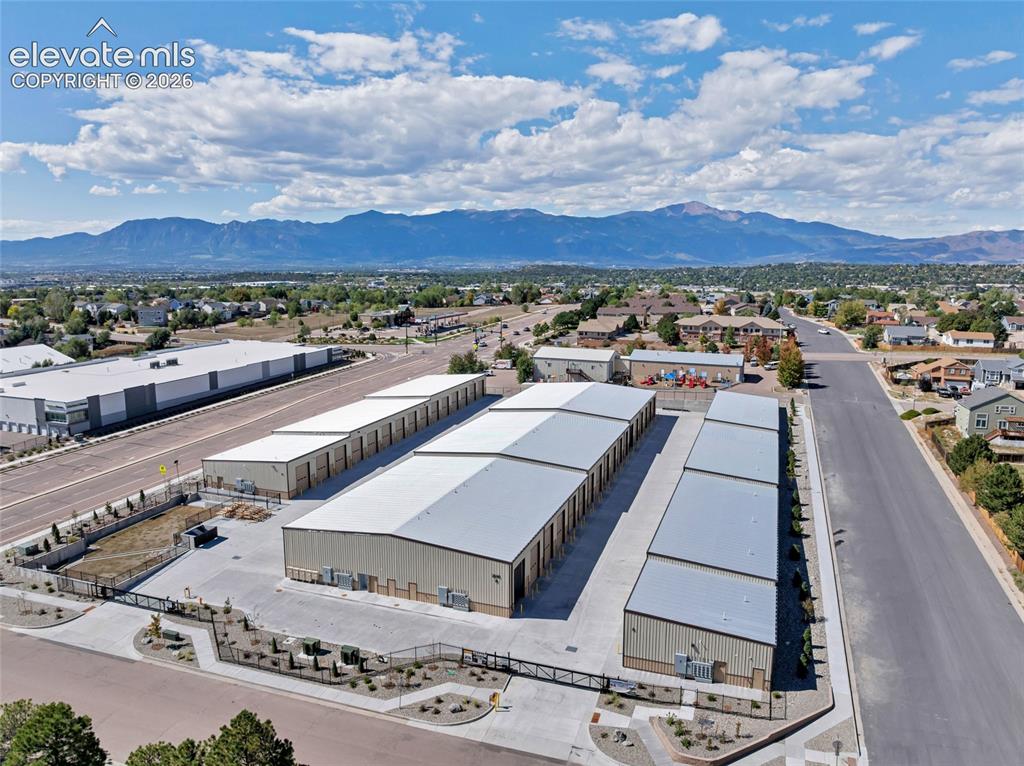Image 1 of 20: Modern storage facility featuring multiple buildings with metal roofs, pave