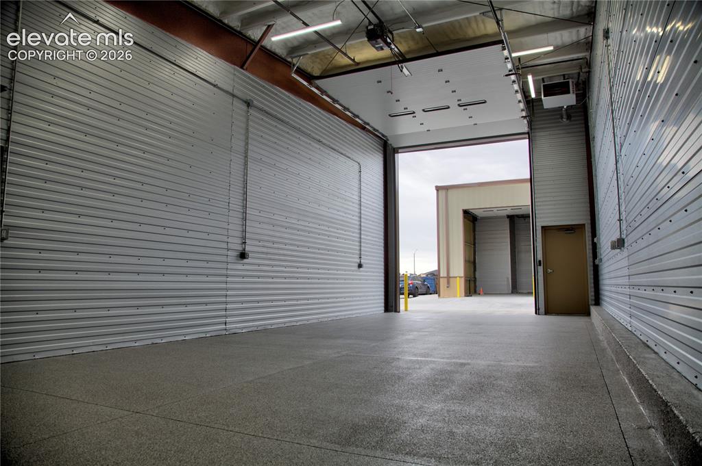 Image 6 of 20: Expansive commercial space featuring high ceilings, multiple overhead doors