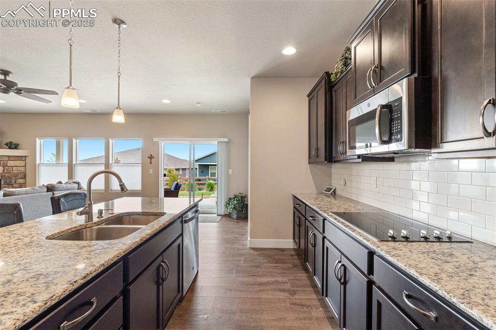 Image 16 of 49: Glass cooktop and tall upper cabinets