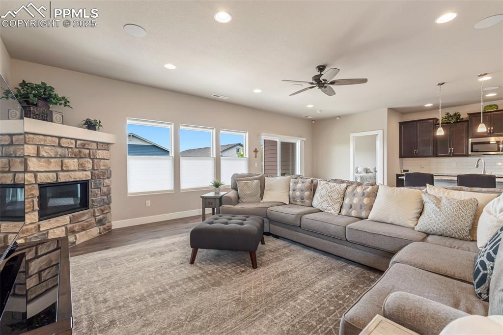 Image 20 of 49: The living room and kitchen have recessed lighting and large windows for pl