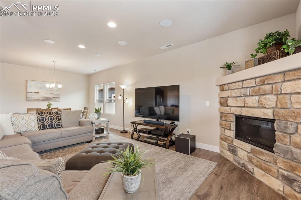 Image 22 of 49: The gas fireplace surrounded by stone is a great decorative piece along wit