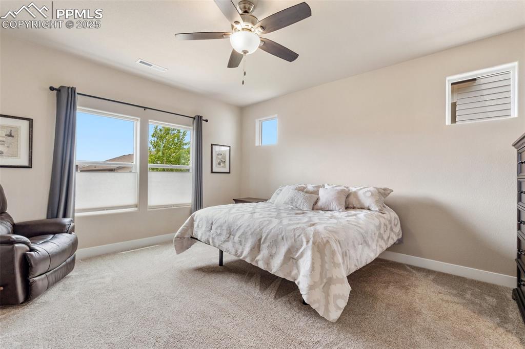 Image 24 of 49: Large primary bedroom with space for many furniture sets