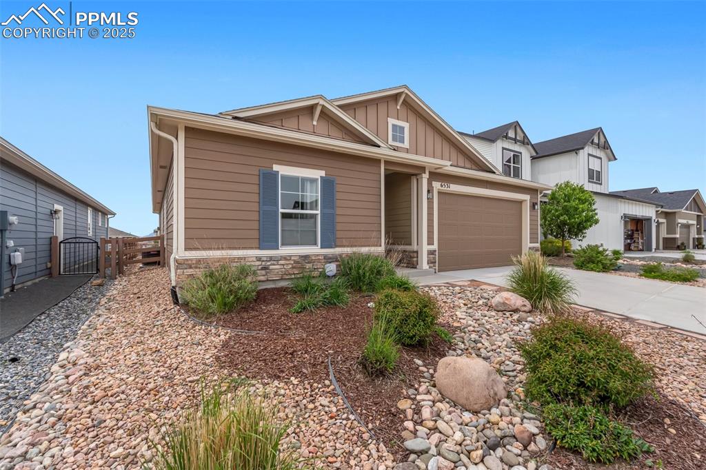 Image 3 of 49: Xeriscape landscaping in the front yard
