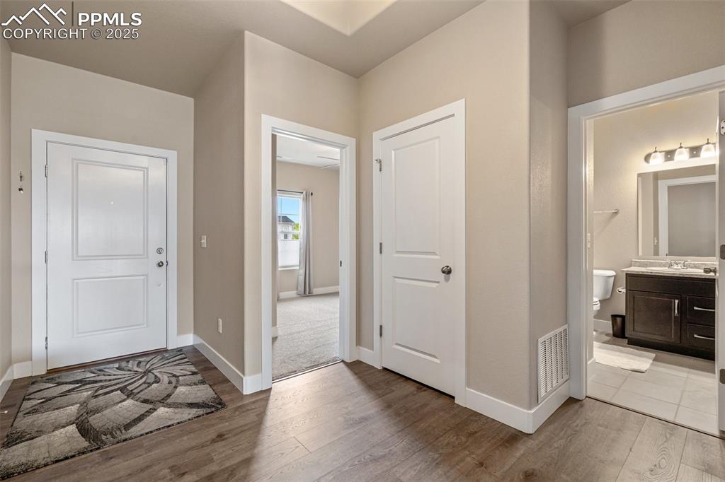 Image 4 of 49: Open front entry with luxury vinyl flooring