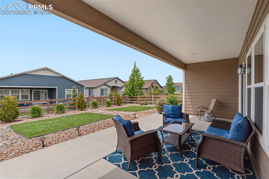 Image 40 of 49: Large covered concrete patio can be enjoyed in rain or shine