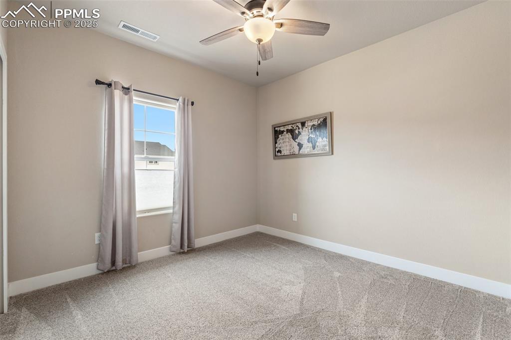 Image 5 of 49: First bedroom off the entry with carpet