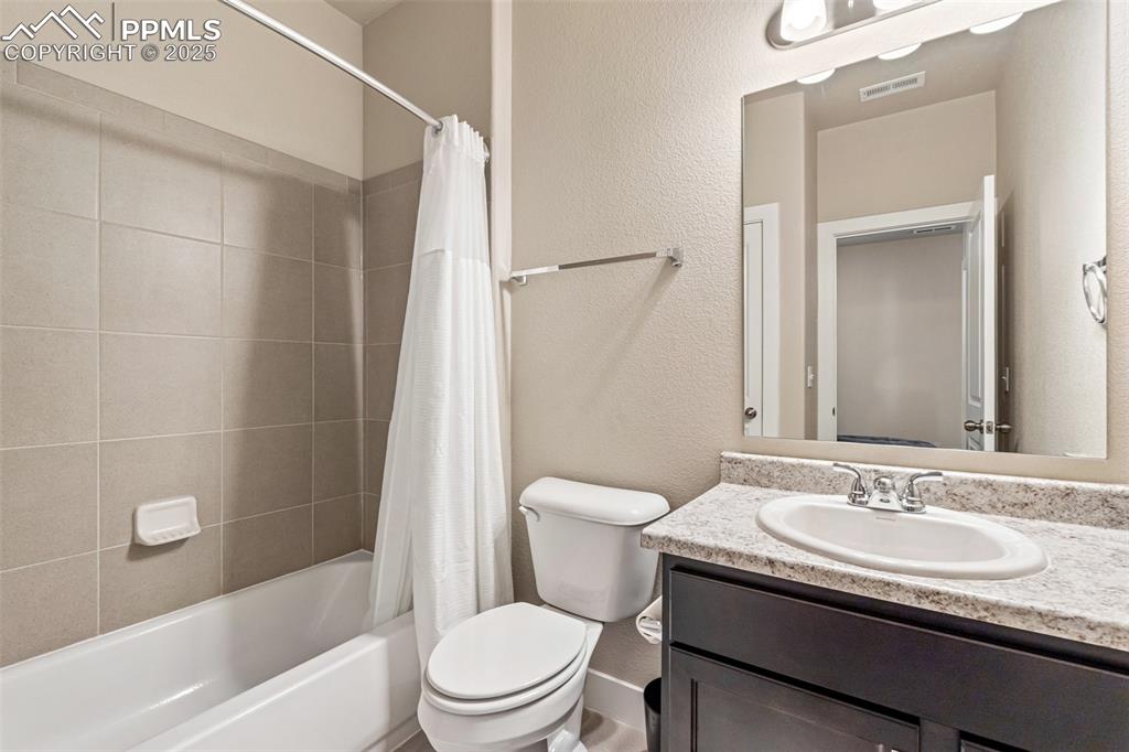 Image 8 of 49: First full bathroom sits between the two front bedrooms
