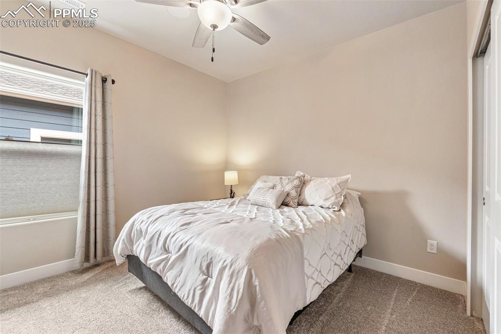 Image 9 of 49: Second front bedroom with ceiling fan