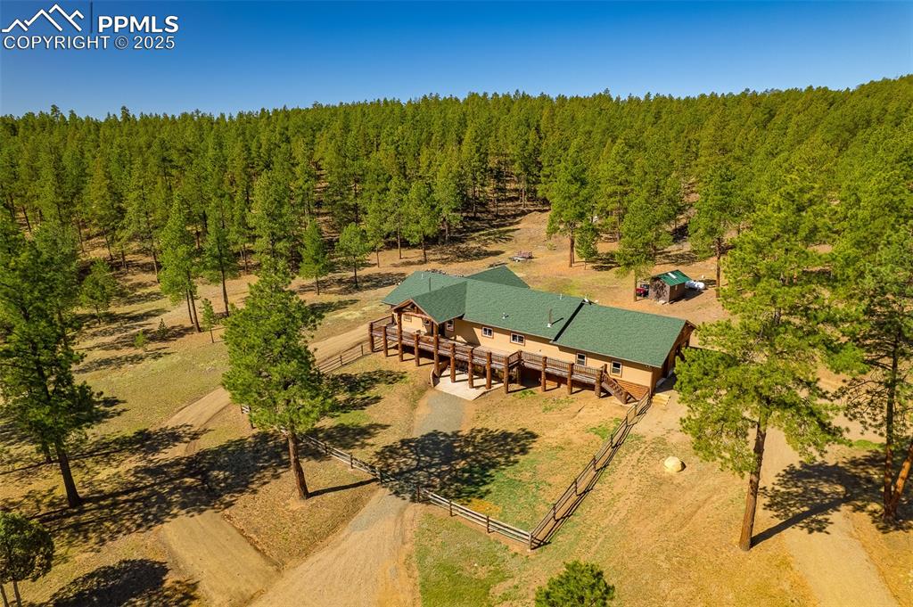 Caption: View from above of property featuring a heavily wooded area