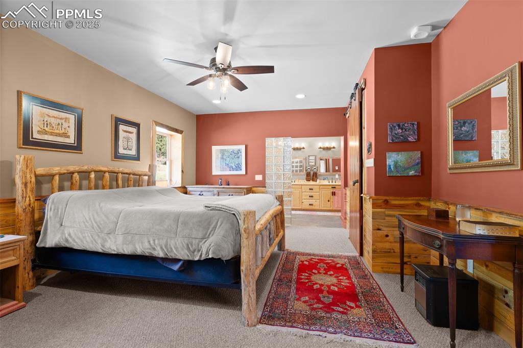 Image 20 of 40: Carpeted bedroom featuring connected bathroom and recessed lighting