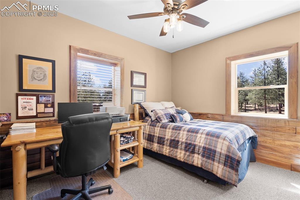 Image 26 of 40: Bedroom with carpet floors, a desk, and a ceiling fan