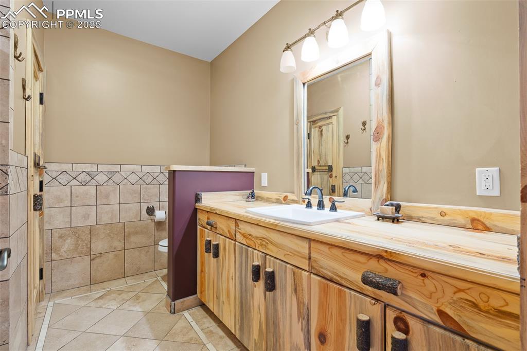 Image 35 of 40: Bathroom with vanity and tile patterned floors