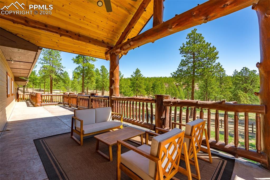 Image 8 of 40: View of patio featuring a wooden deck and an outdoor living space