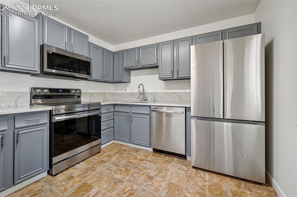 Image 12 of 27: Kitchen with stainless steel appliances