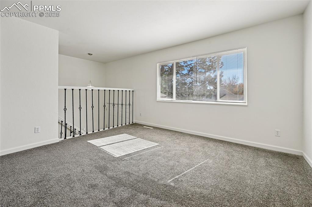 Image 14 of 27: Unfurnished room with carpet floors