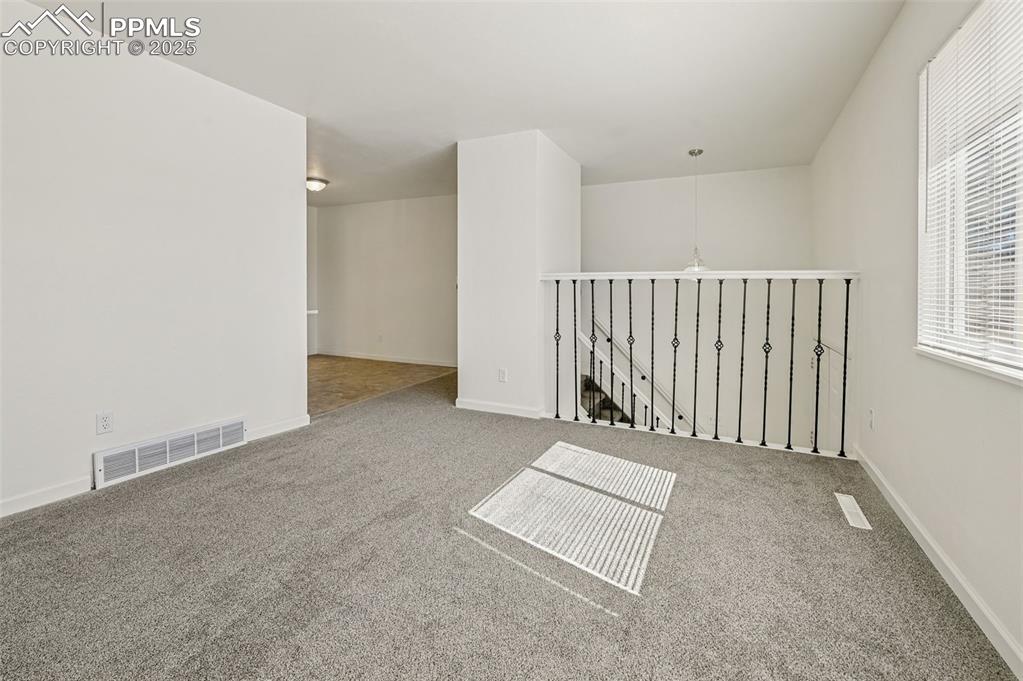 Image 15 of 27: Spare room with carpet floors and baseboards