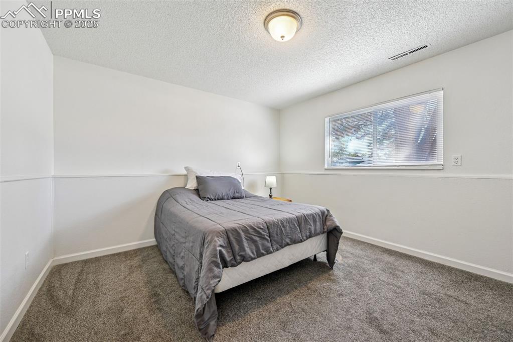 Image 23 of 27: Bedroom featuring carpet floors and a textured ceiling