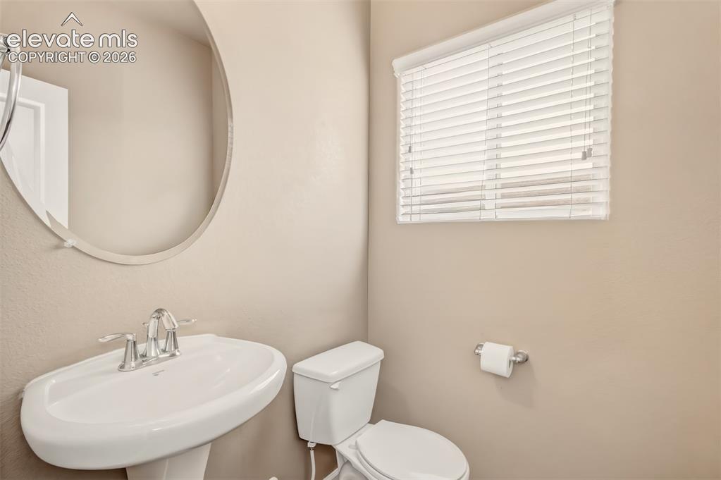 Image 14 of 22: half bath adjacent to kitchen