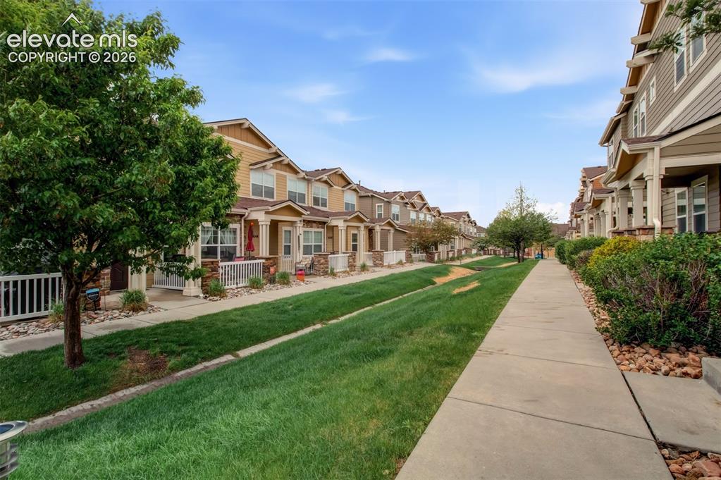 Image 7 of 22: Greenblet i front of the townhome