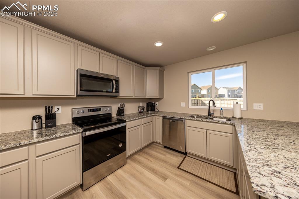 Image 12 of 32: Kitchen featuring appliances with stainless steel finishes, recessed lighti