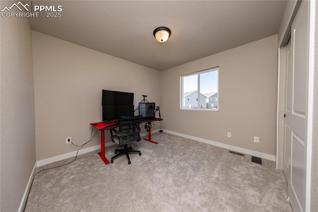 Image 16 of 32: Office featuring light carpet and baseboards