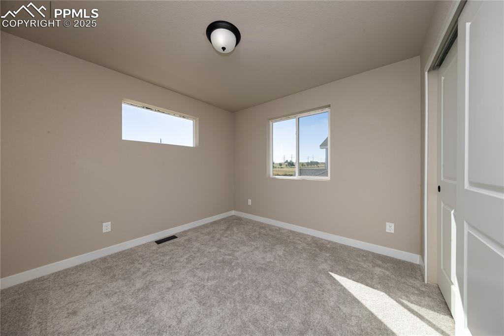 Image 17 of 32: Unfurnished bedroom featuring light colored carpet and a closet