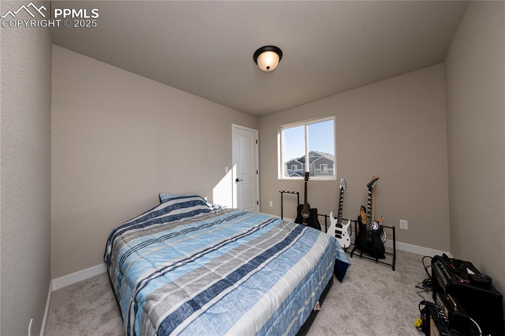 Image 20 of 32: Bedroom with light colored carpet and baseboards